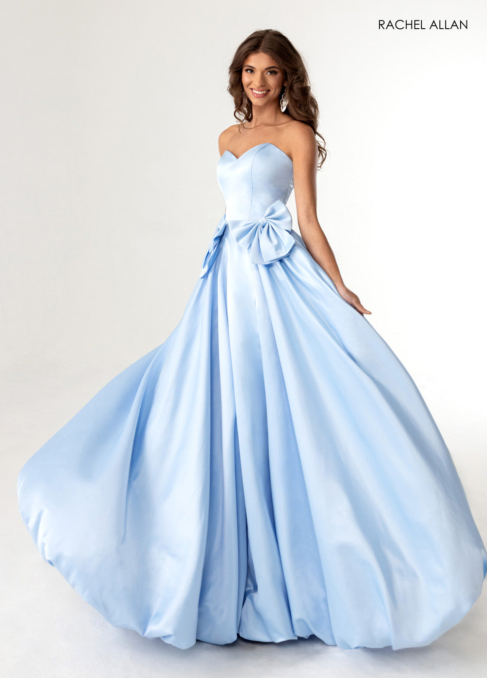 Rachel Allan 71035 Strapless powder blue prom dress with a full skirt and oversized bow detail.