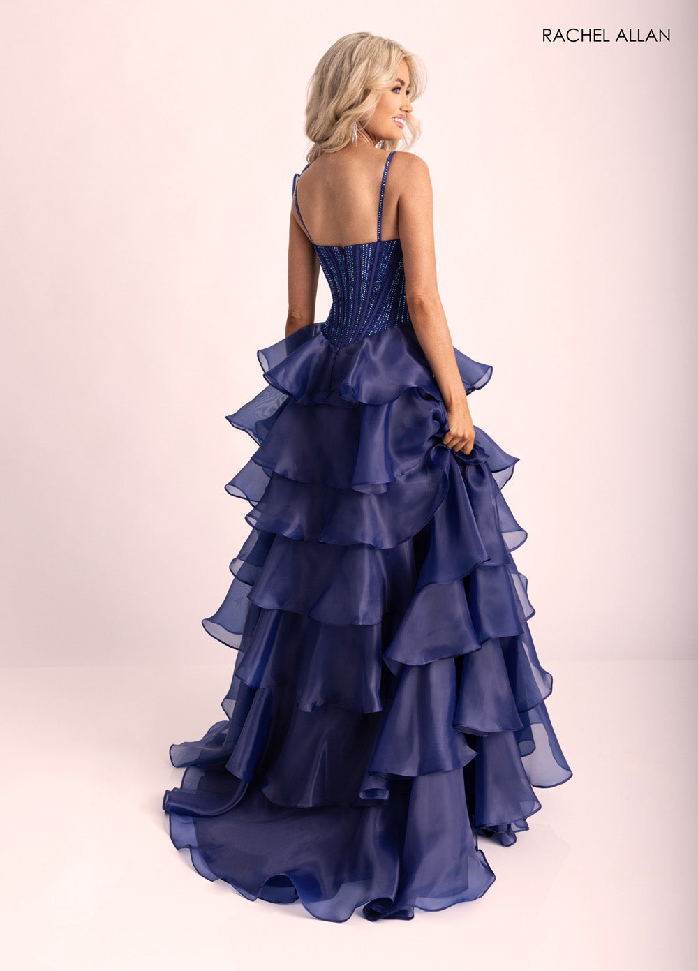 Rachel Allan 71049 Navy mermaid prom dress with crystal beading and layered organza ruffles, back view.