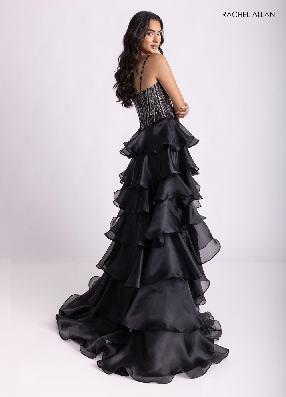 Rachel Allan 71049 Black mermaid prom dress with crystal beading and layered ruffles, back view.