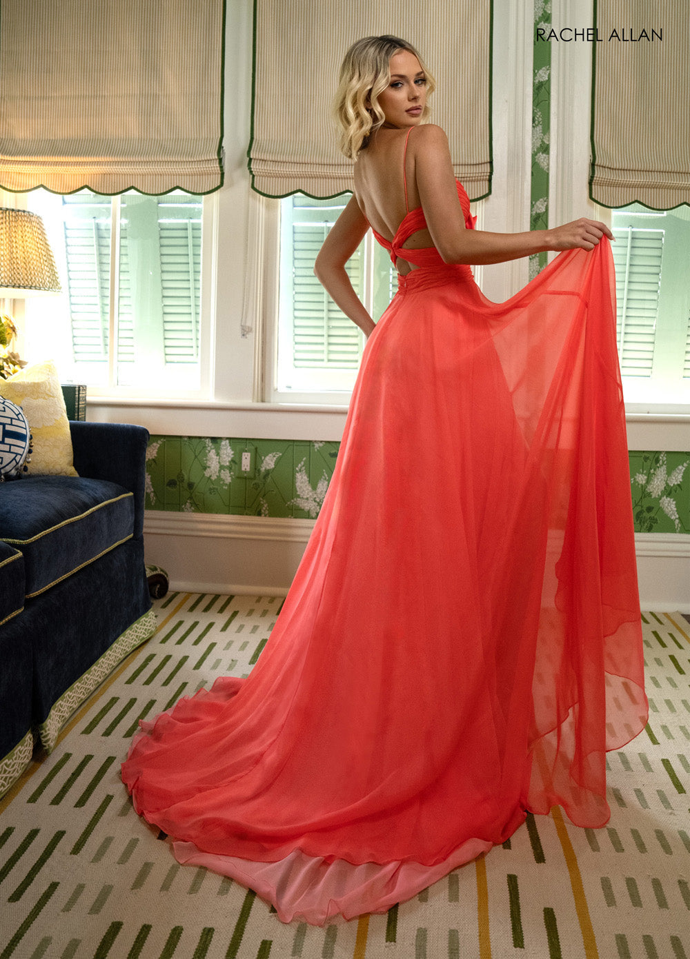 Rachel Allan 71050 Coral chiffon prom dress with a flowing silhouette and lace-up back, back view.