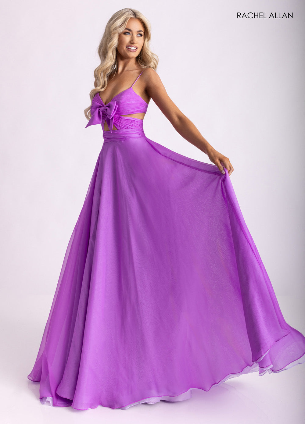 Rachel Allan 71050 Purple A-line prom dress with a bow detail and flowing chiffon skirt.