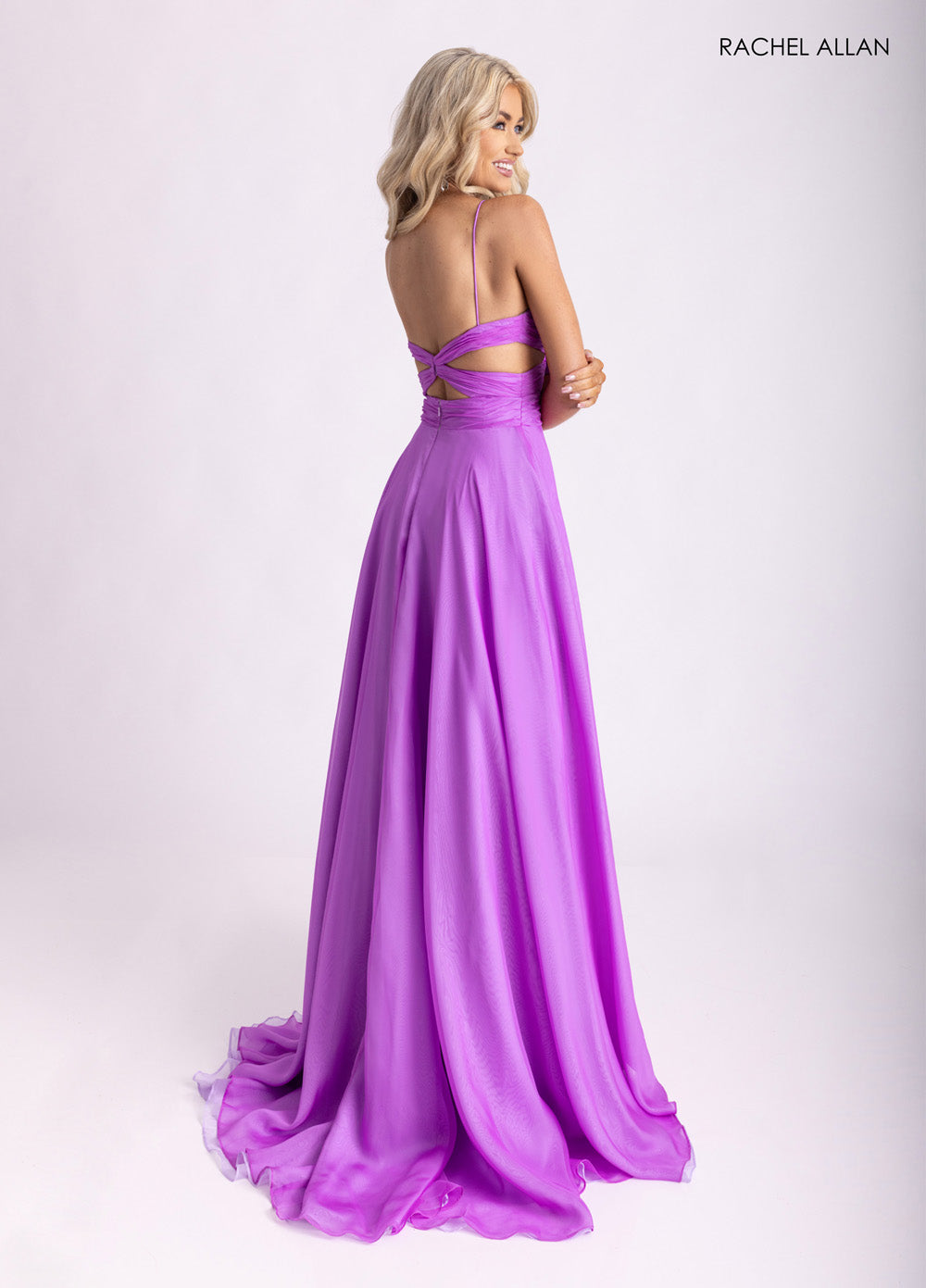 Rachel Allan 71050 Back view of a lavender A-line prom dress with crisscross straps and flowing skirt.