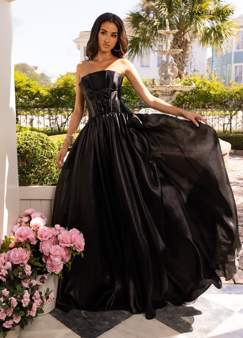 Rachel Allan 71060 Black A-line prom dress with a bow detail and flowing skirt.