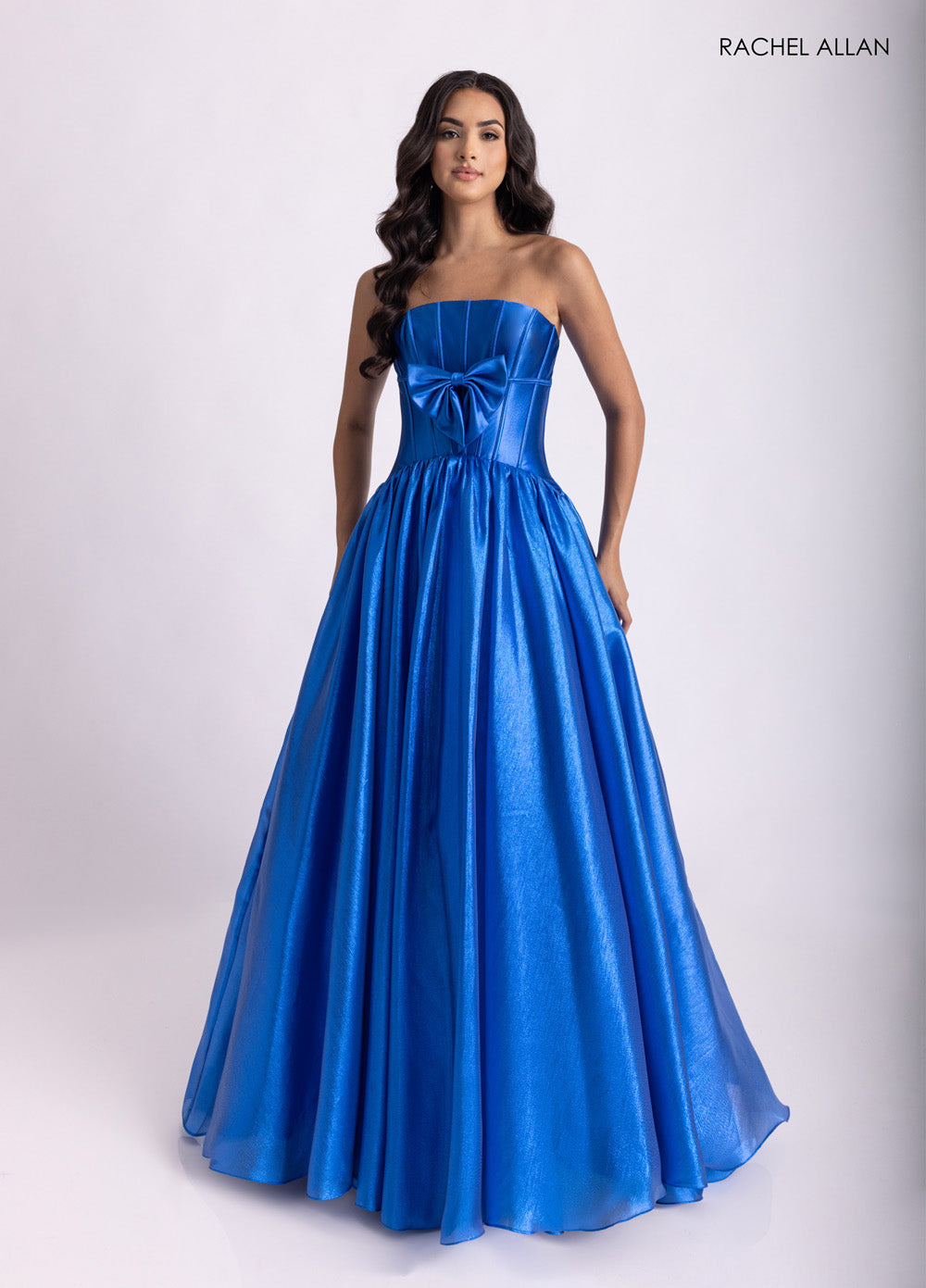 Rachel Allan 71060 Strapless royal blue prom dress with a bow detail and full A-line silhouette.