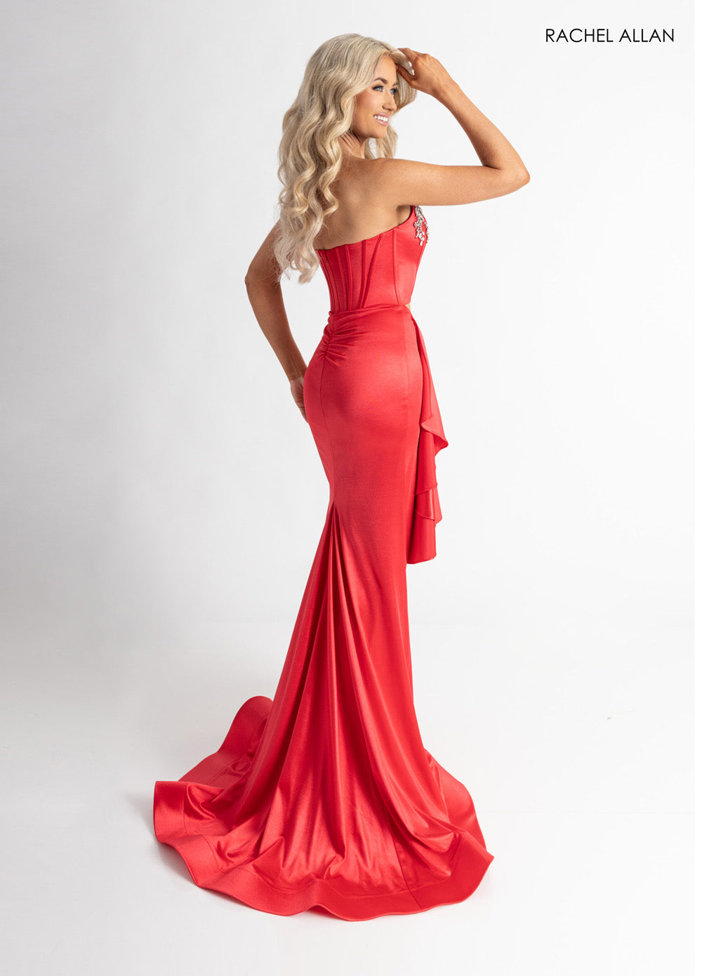 Rachel Allan 71061 Red mermaid prom dress with crystal beading and a dramatic train, side view.