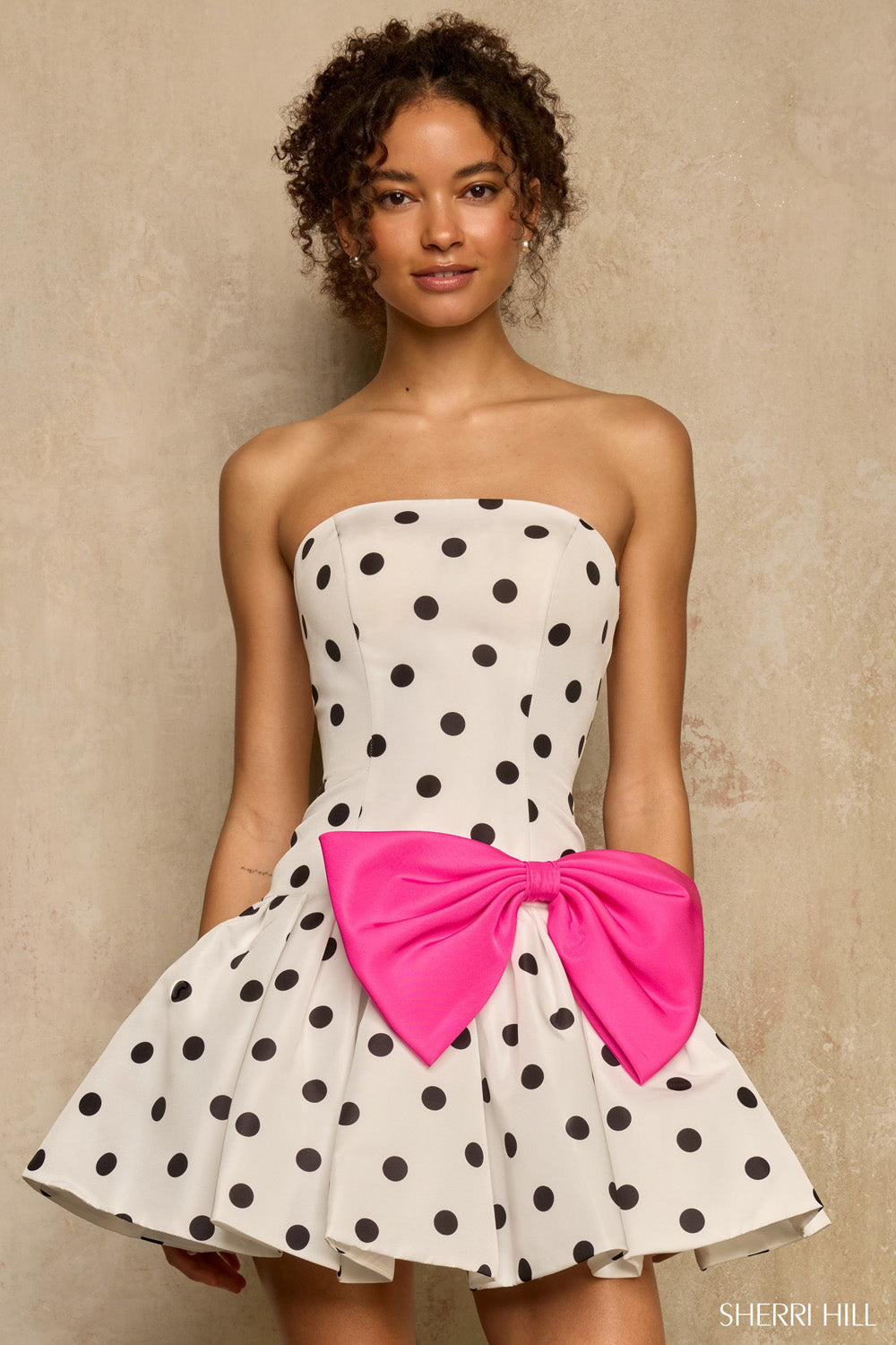 Sherri Hill 57989 white black polka dot strapless mini dress with oversized hot pink bow at waist, front view