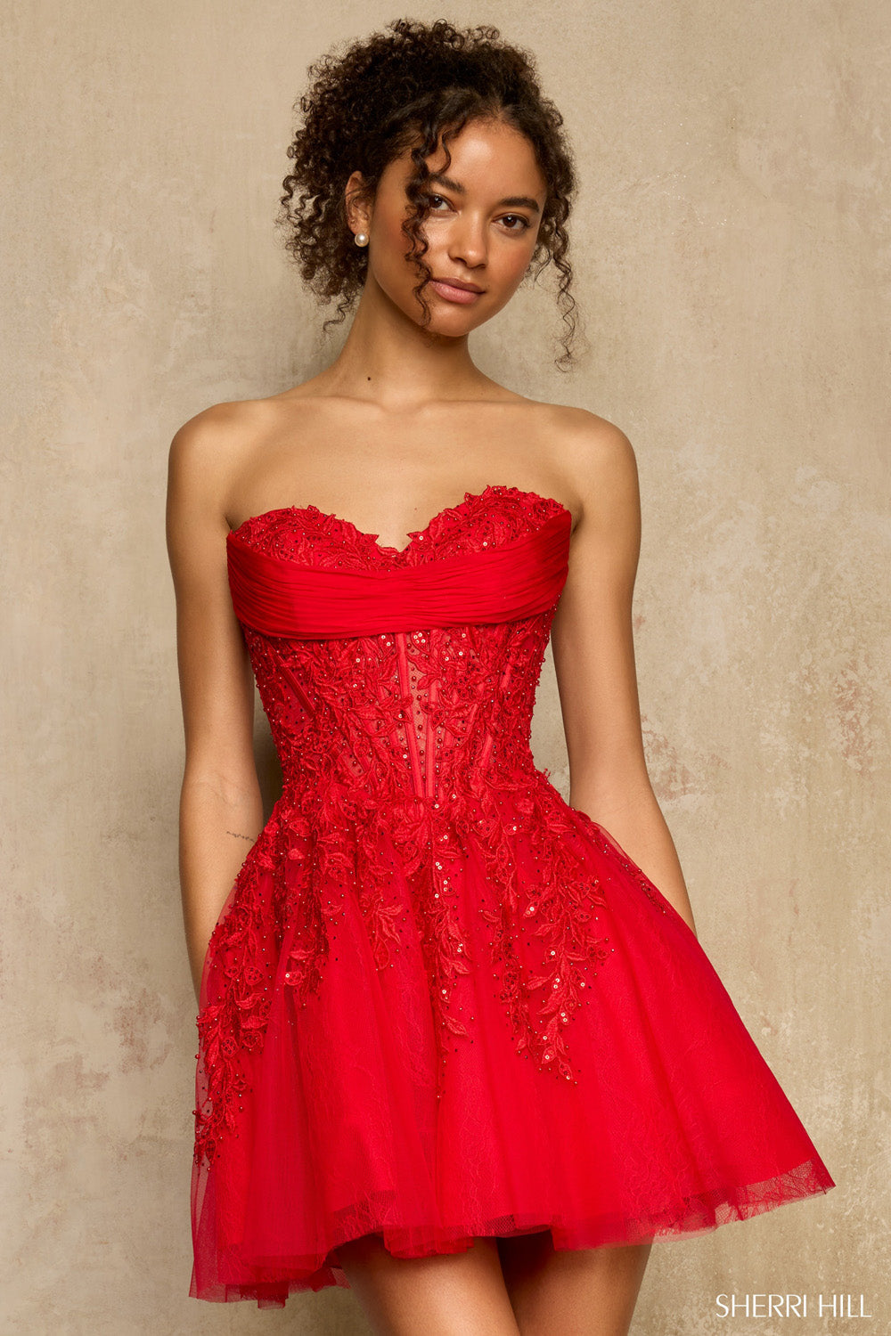 Sherri Hill 58116 red strapless homecoming dress, front view with ruched bandeau top, beaded corset, and flared tulle skirt.