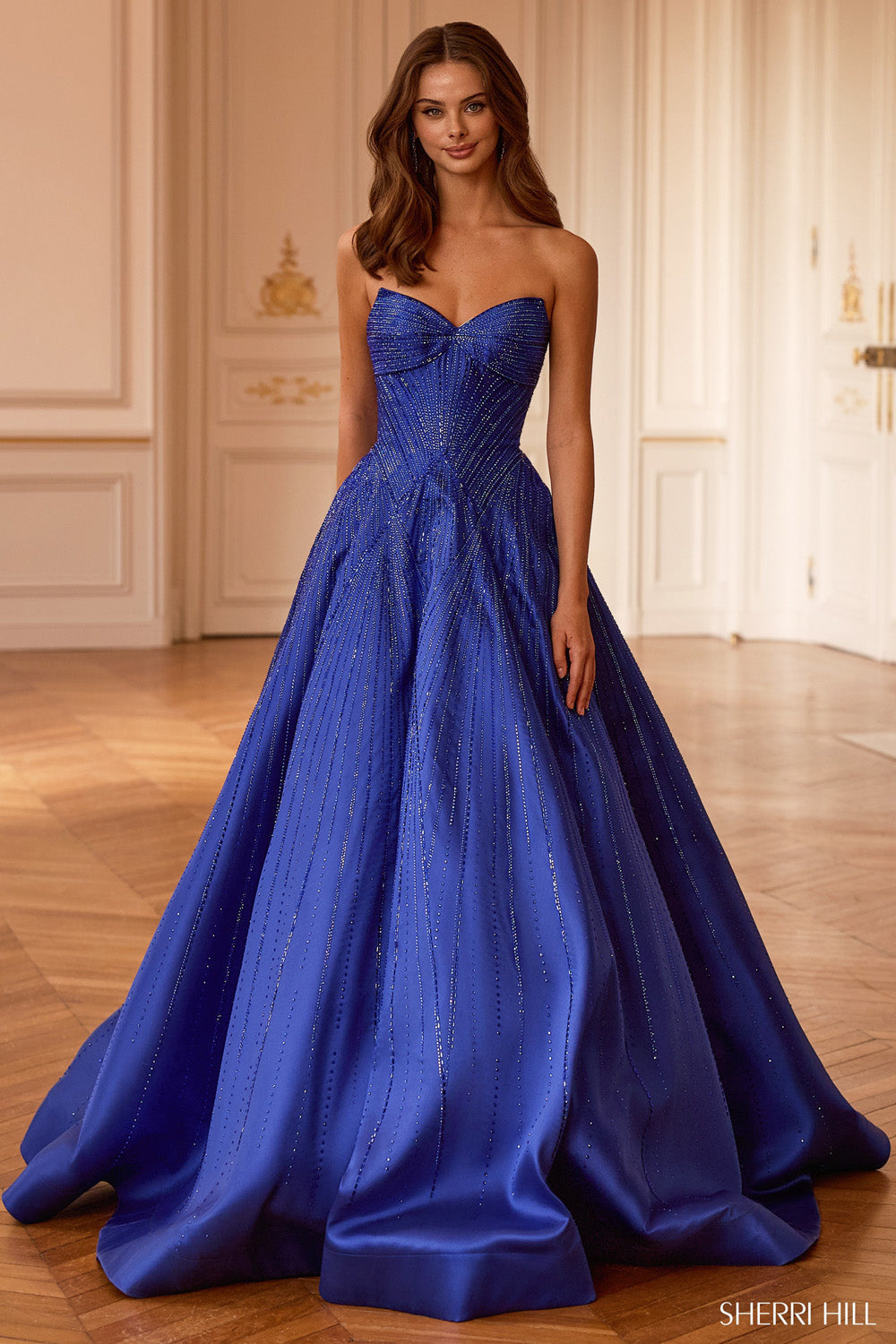 Sherri Hill 58327 royal blue beaded ballgown, three-quarter front view showing crystal waterfall embellishment and voluminous mikado skirt.
